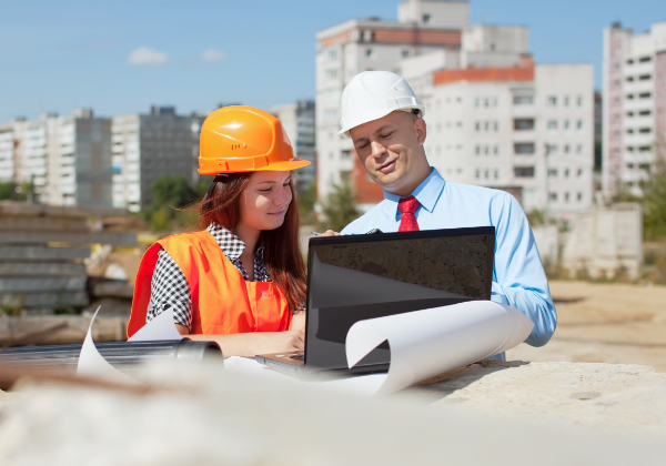 Two architects  in front of building site